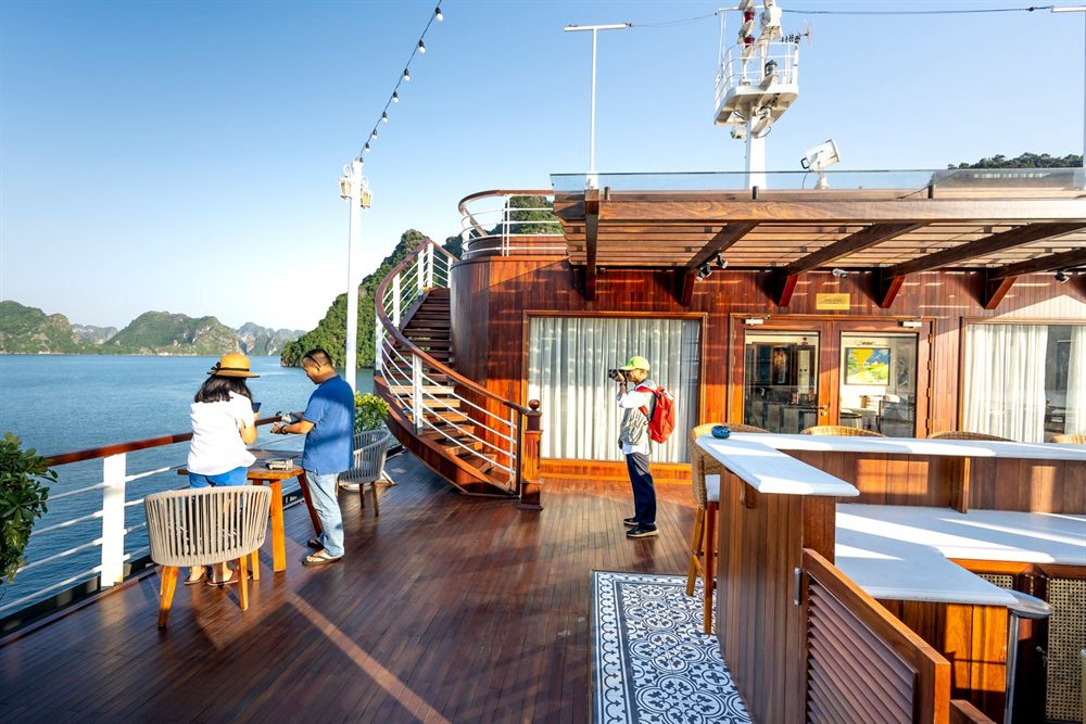 Passengers enjoying the view from the sunny deck of a cruise ship